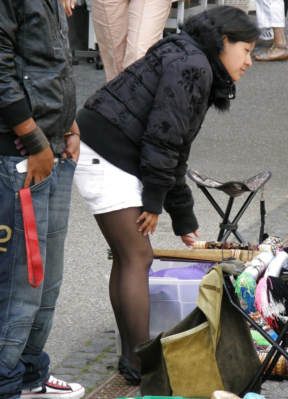 7P Cute south american street seller, wearing black pantyhose