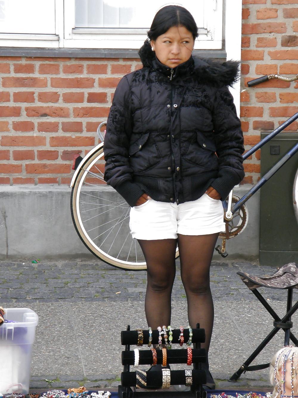 7P Cute south american street seller, wearing black pantyhose