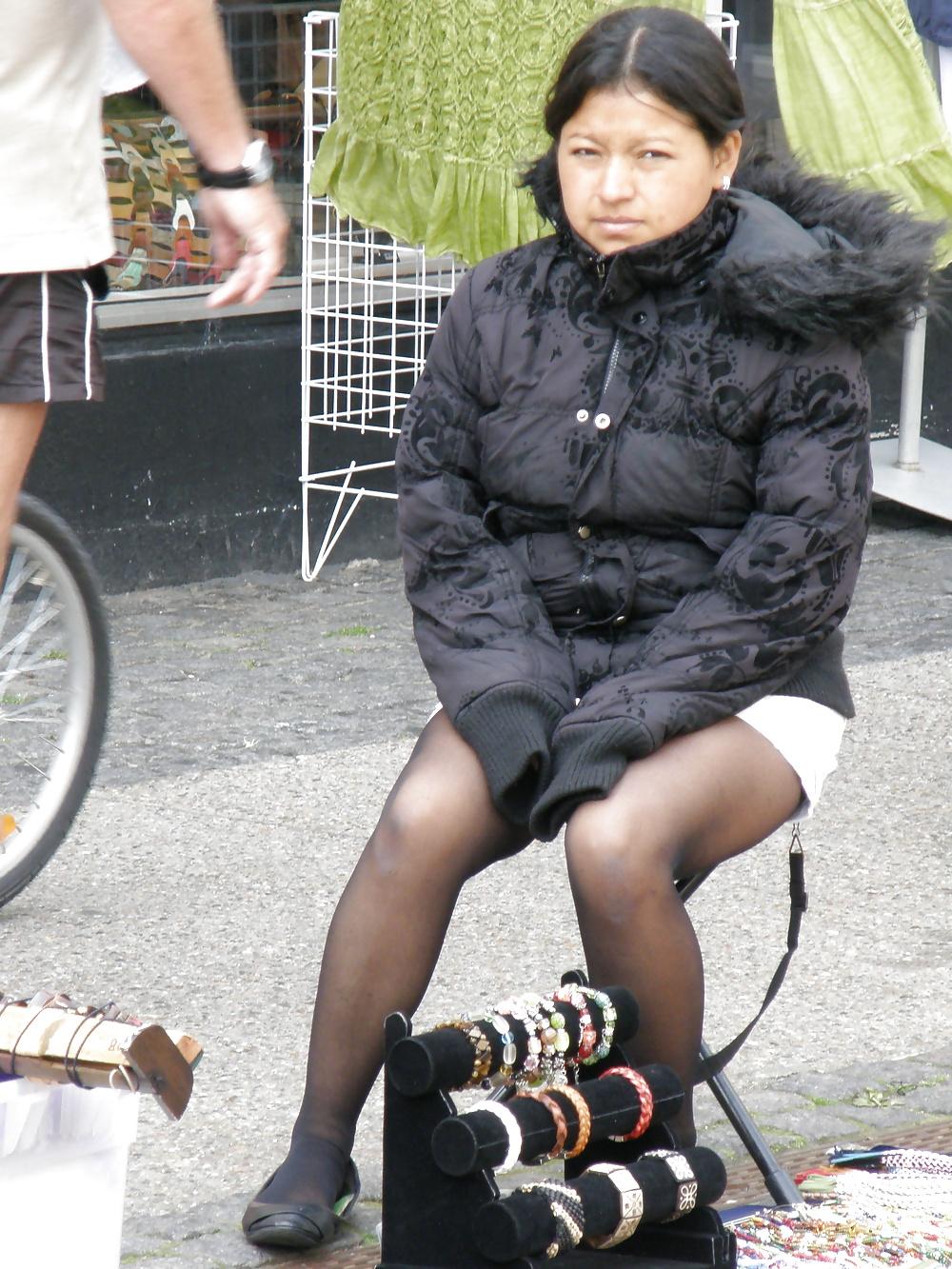 7P Cute south american street seller, wearing black pantyhose