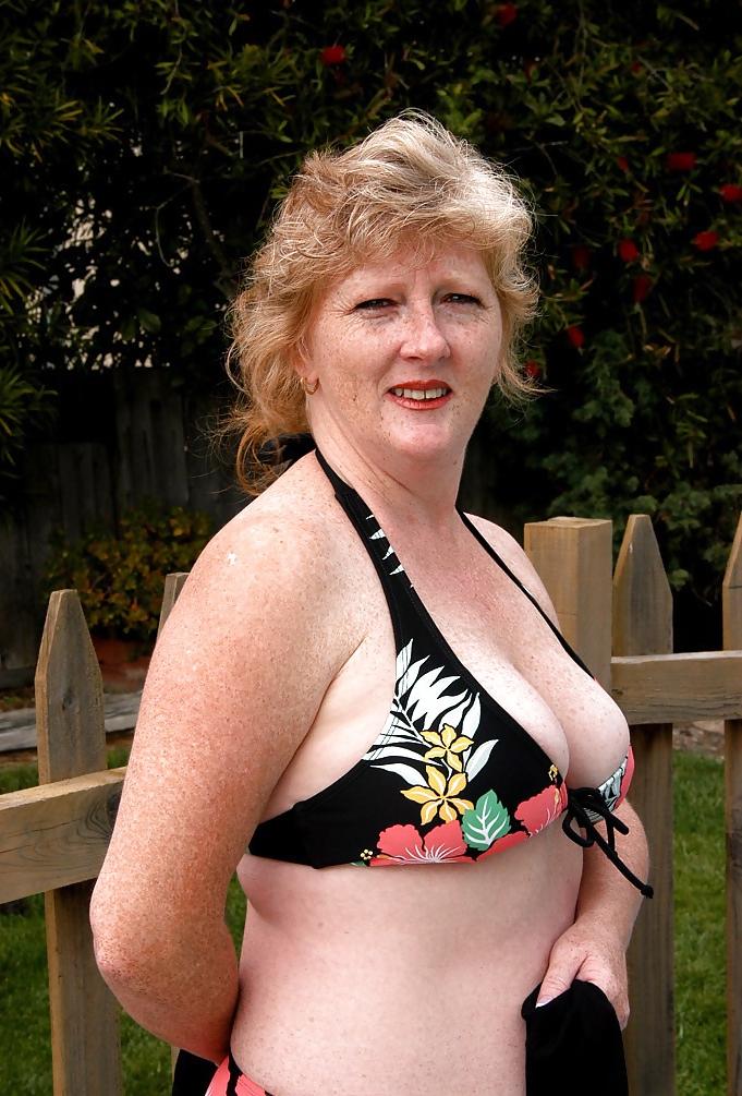 12P Redhead removes bikini  in the garden