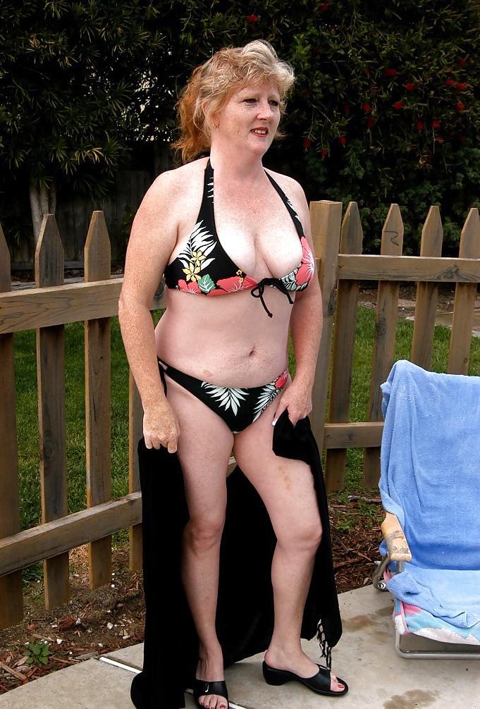 12P Redhead removes bikini  in the garden