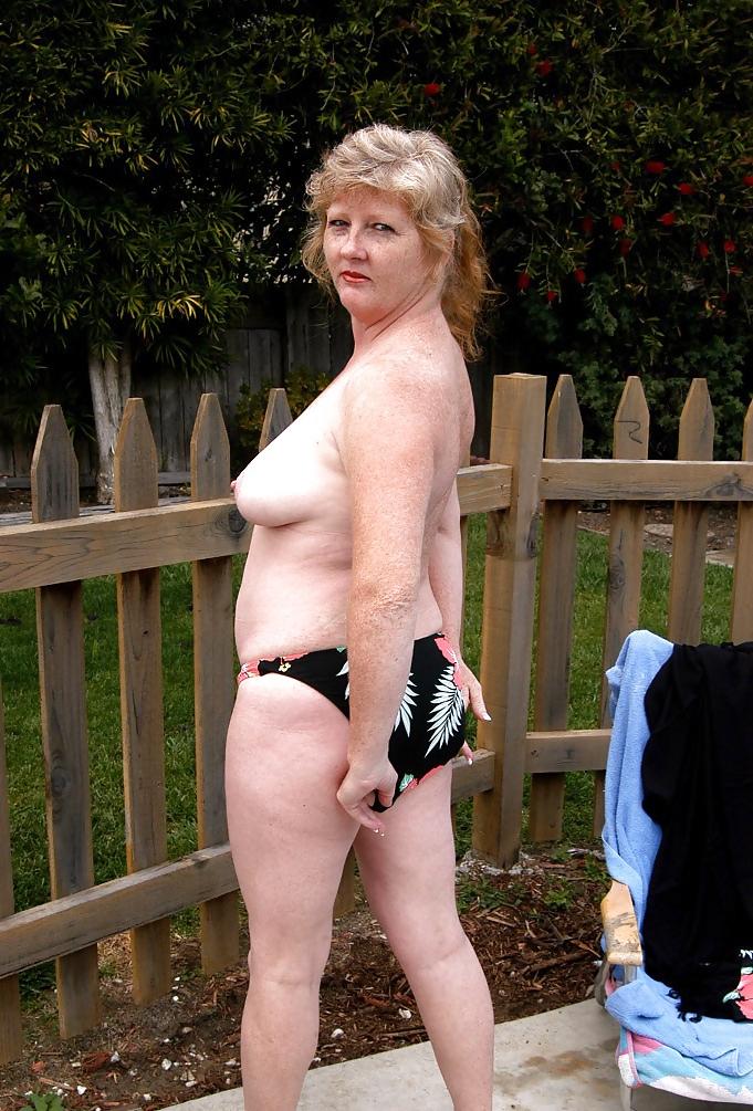 12P Redhead removes bikini  in the garden