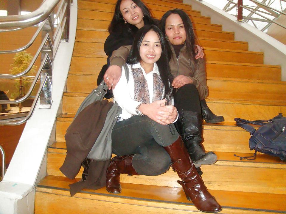 25P S. E. ASIANS  IN  GREEK  STREETS  WEARING  BOOTS