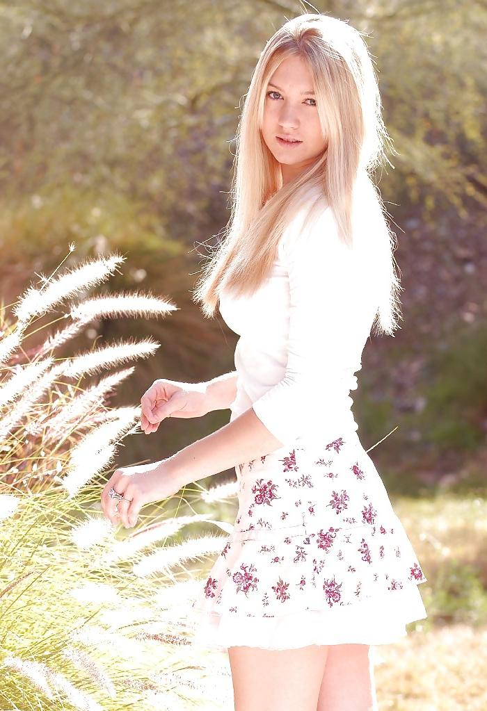 25P Hot busty blonde posing in a garden