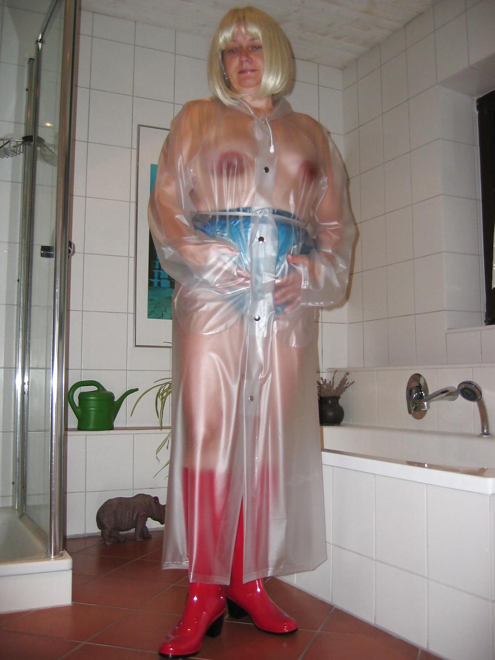 12P My wife wearing a transparent raincoat with rubber boots