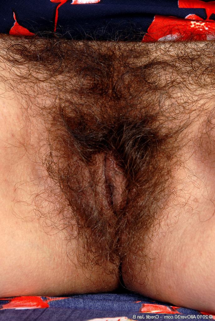 16P Old big breasted granny takes off her skirt and shows off her old hairy muff.