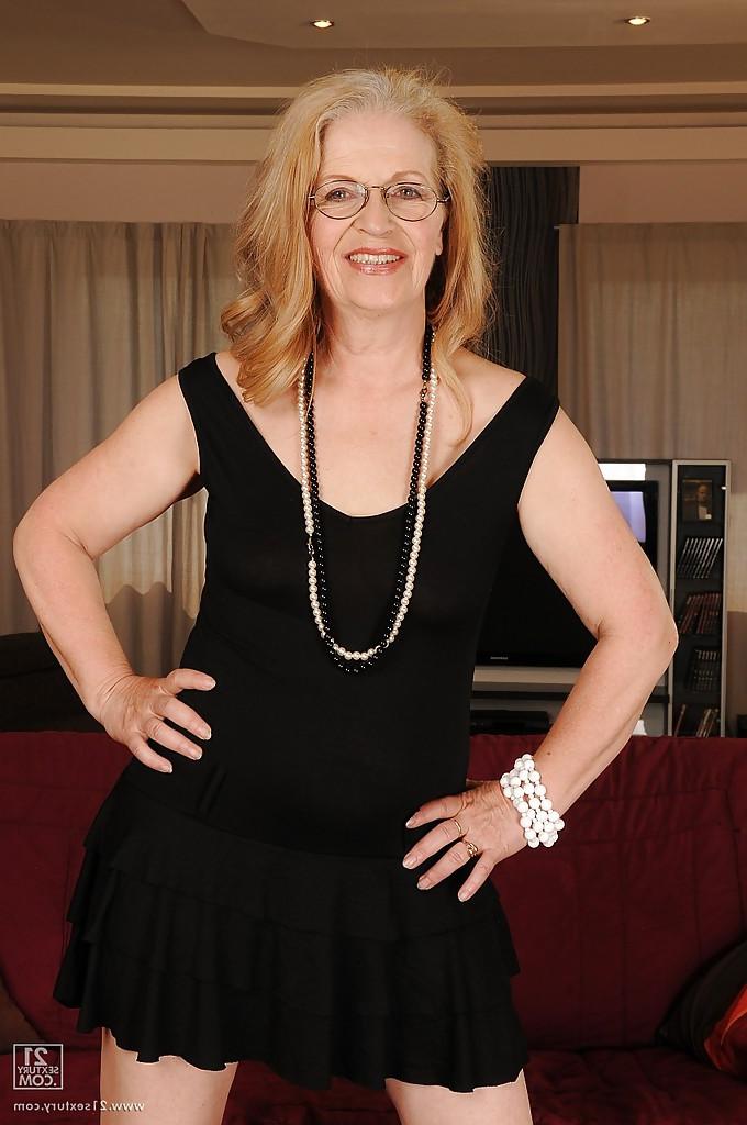 13P Naughty granny in glasses revealing her big flabby jugs and shaved cunt