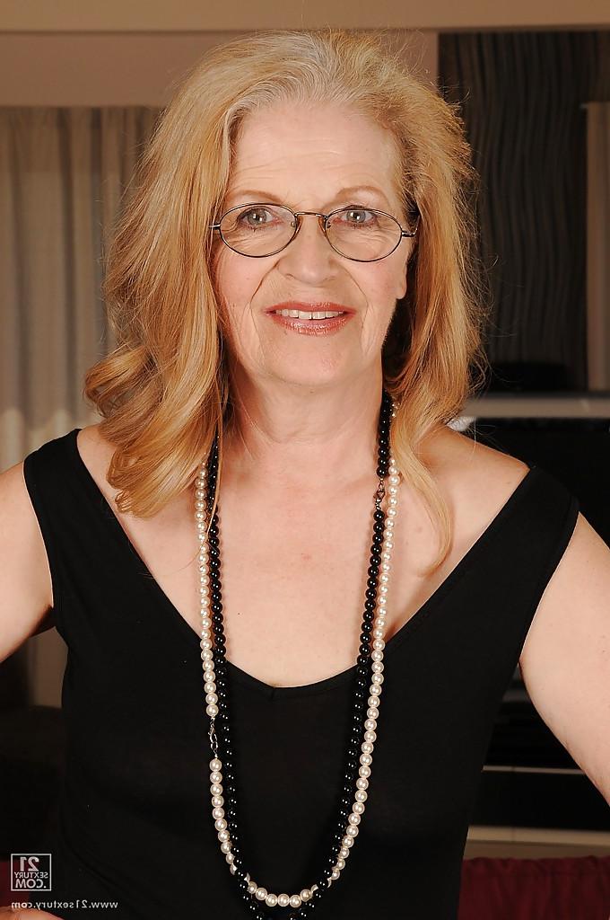13P Naughty granny in glasses revealing her big flabby jugs and shaved cunt