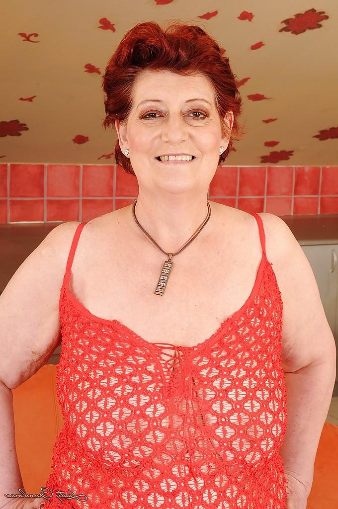 16P Fatty redhead granny with big flabby tits taking off her lingerie