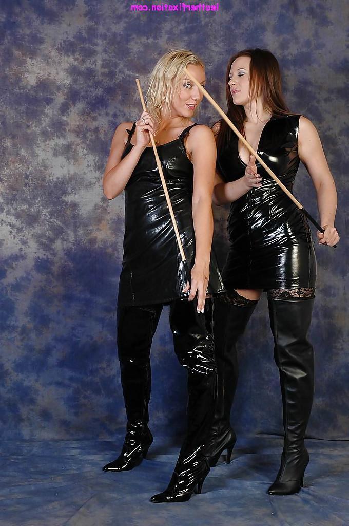 16P Non nude Dominatrixes in latex and leather boots whip each others ass