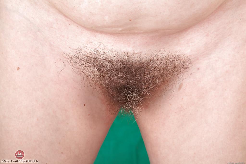 16P Chunky mature lady in glasses Christina X pulls panties aside to flash bush