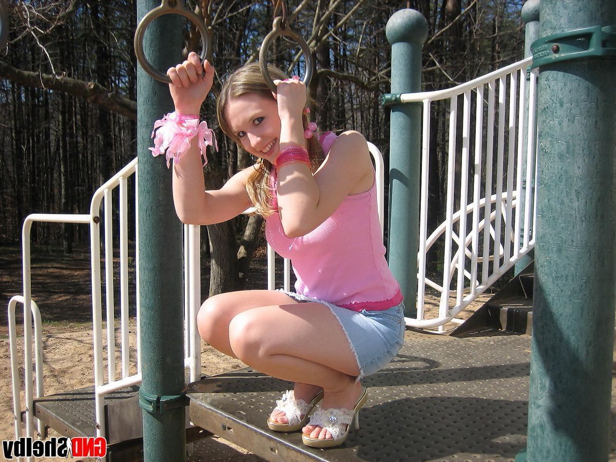 12P Petite teen Shelby isnt shy as she flashes her pussy and shows off her tight ass at the playground