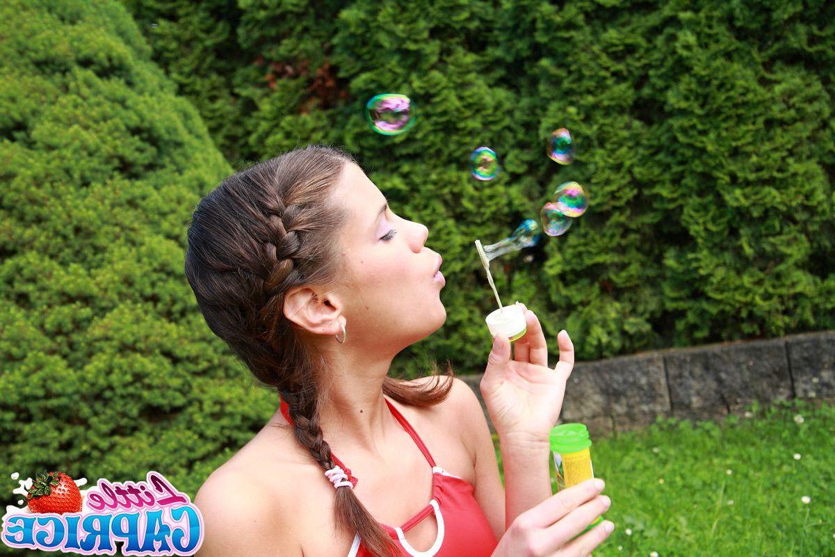 15P Pictures of teen slut Little Caprice masturbating in the grass