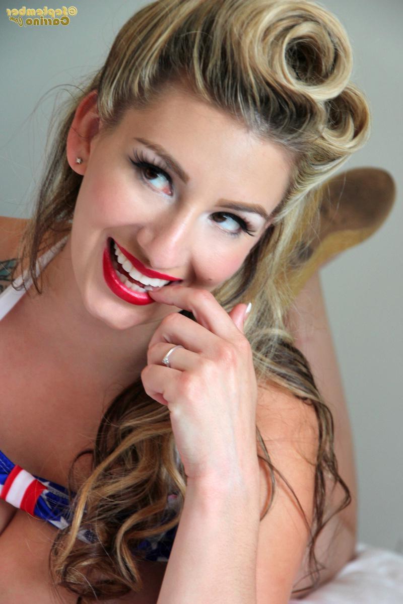 15P Busty pinup babe September Carrino falls out fo her American flag bikini