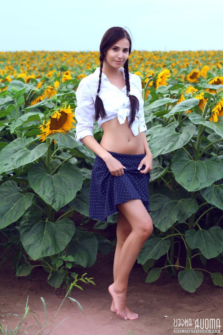 20P Beautiful teen Vanessa Sky strips down to her pigtails in the sunflower garden