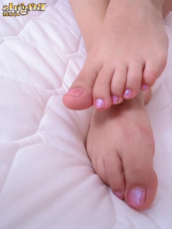 15P Brunette teen in pigtails pulls off her striped socks and plays with her toes