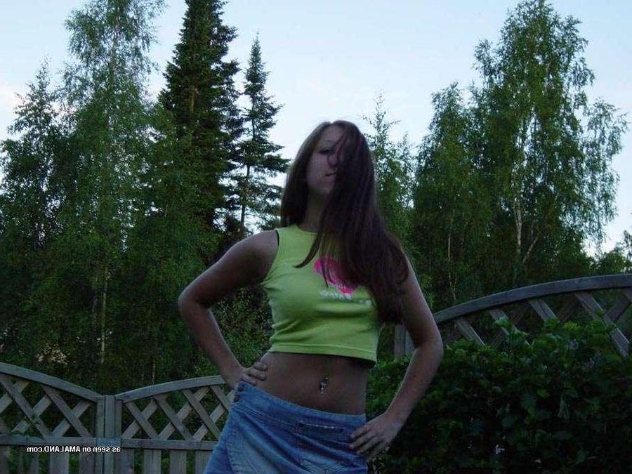 15P Sexy brunette cutie wearing a mini skirt posing in the garden