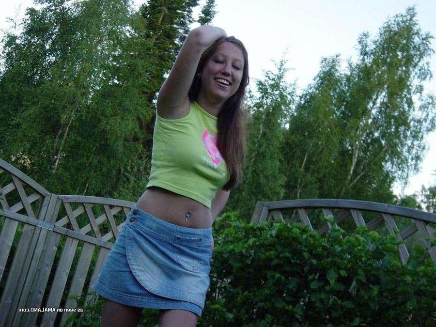 15P Sexy brunette cutie wearing a mini skirt posing in the garden