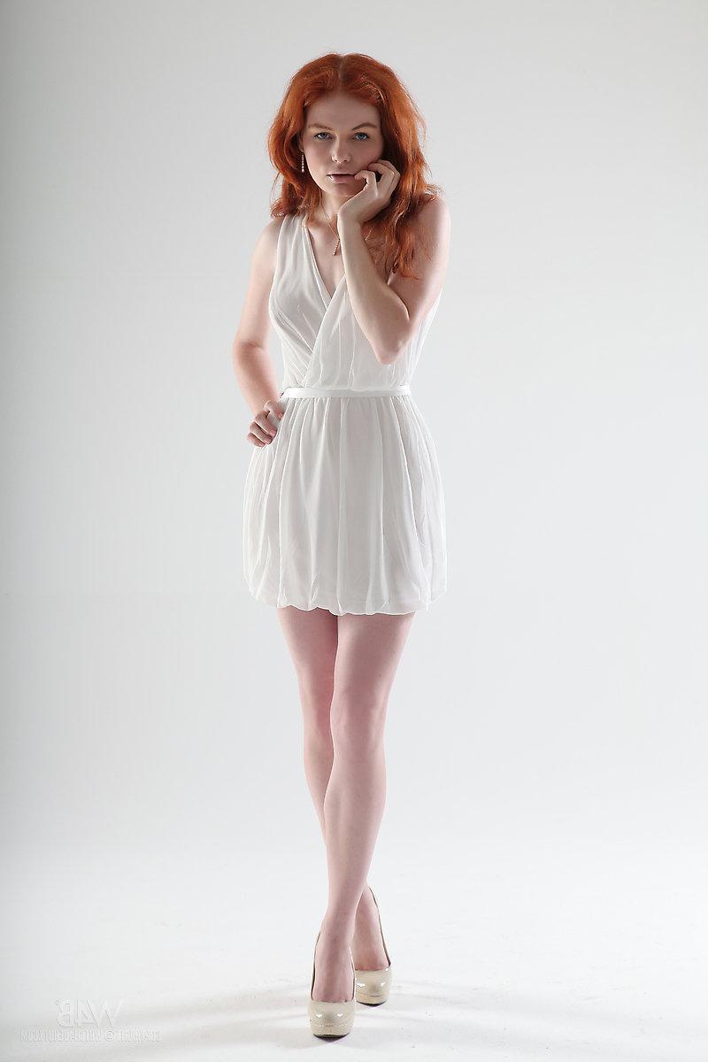 16P Beautiful redhead Barbara Babeurre strips out of her white dress in the studio