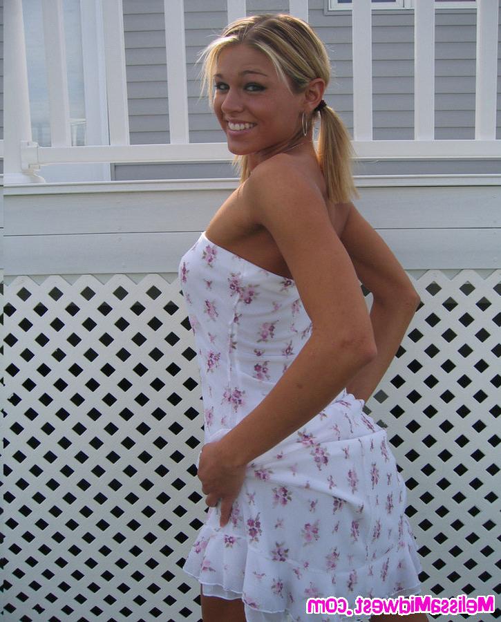 16P Melissa Midwest posing in a whit dress in the grass