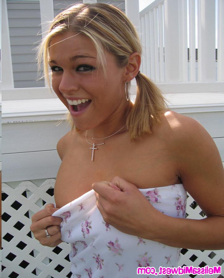 16P Melissa Midwest posing in a whit dress in the grass
