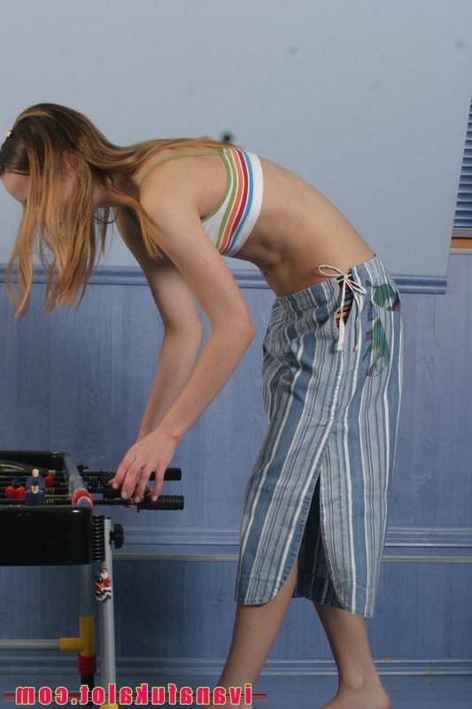 15P Two pretty teens playing table soccer