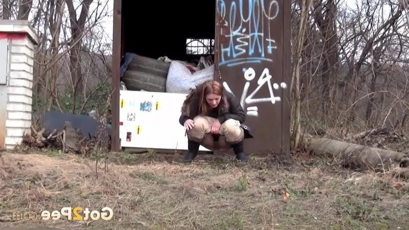 15P Brunette girl pulls down her trousers to pee outside