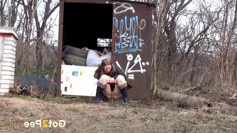 15P Brunette girl pulls down her trousers to pee outside