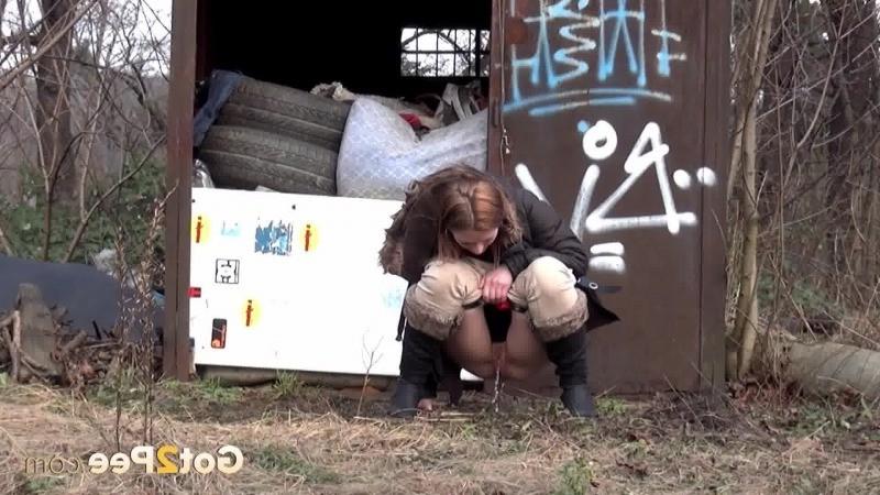 15P Brunette girl pulls down her trousers to pee outside