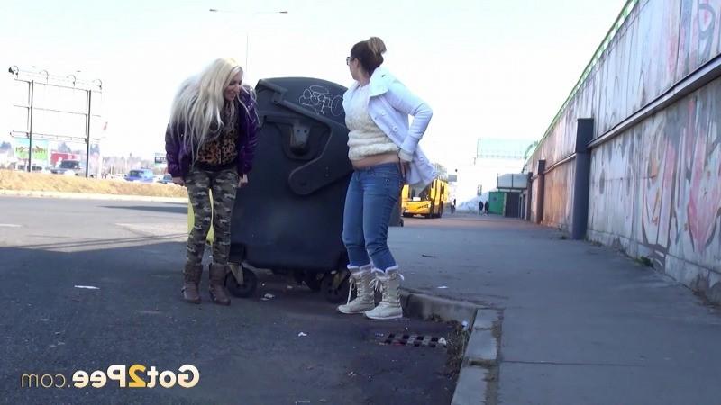 15P Two girlfriends piss in public next to bus stop