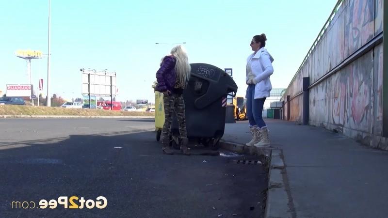 15P Two girlfriends piss in public next to bus stop
