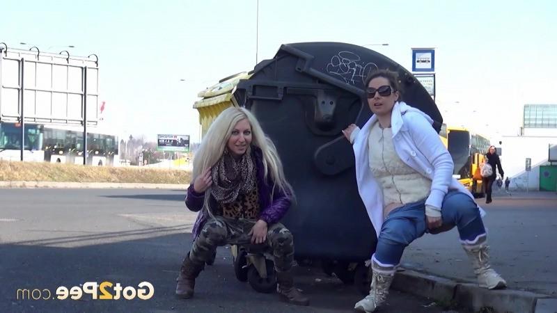15P Two girlfriends piss in public next to bus stop