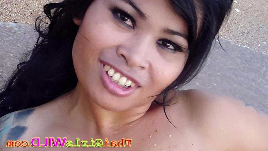16P Huge tits Thai hottie Noot rolls on the beach showing off her tits