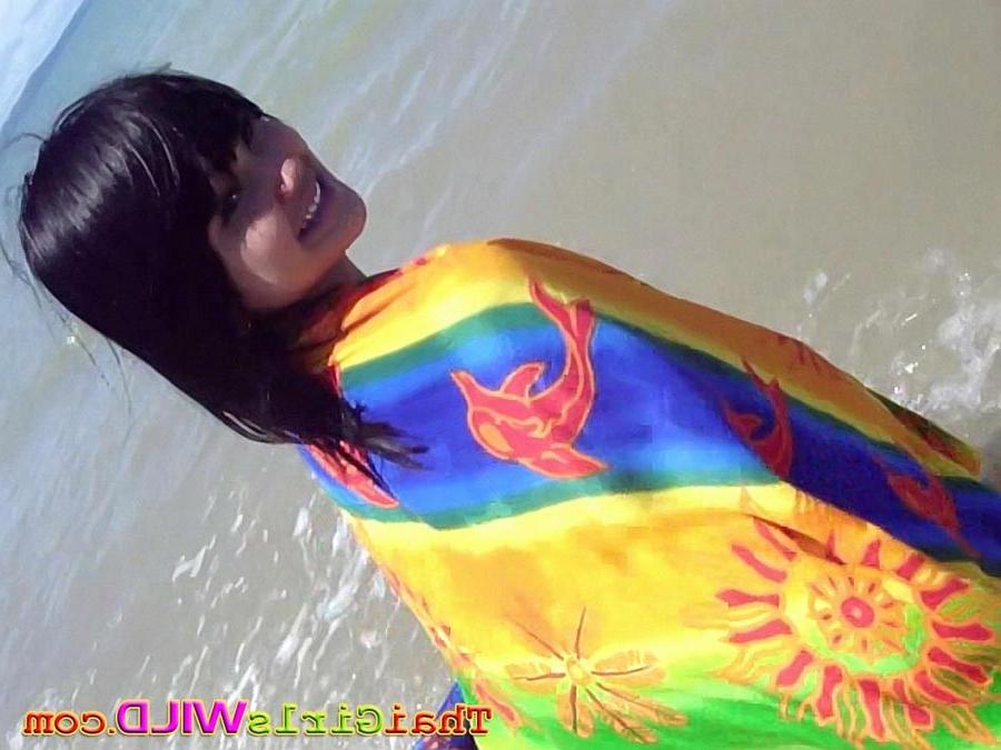 16P Hot teen Thai babe Febe flashes her perky tits at the beach