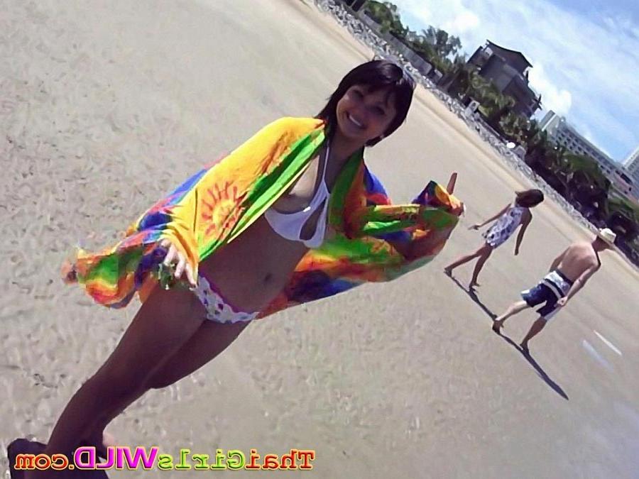 16P Hot teen Thai babe Febe flashes her perky tits at the beach