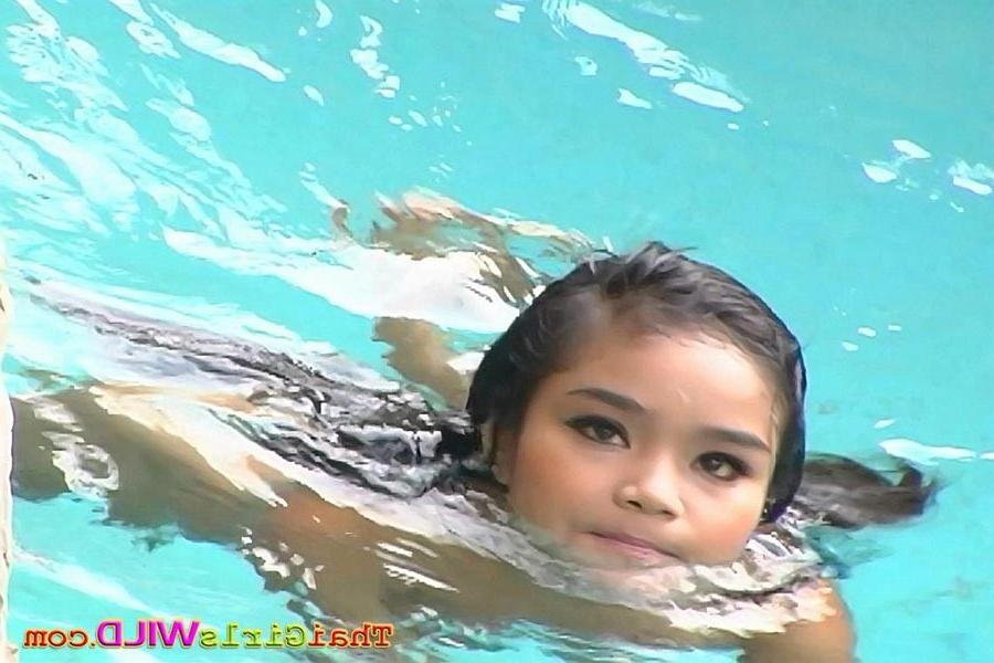16P Tiny Thai babe Panni swimming nude outside at the pool