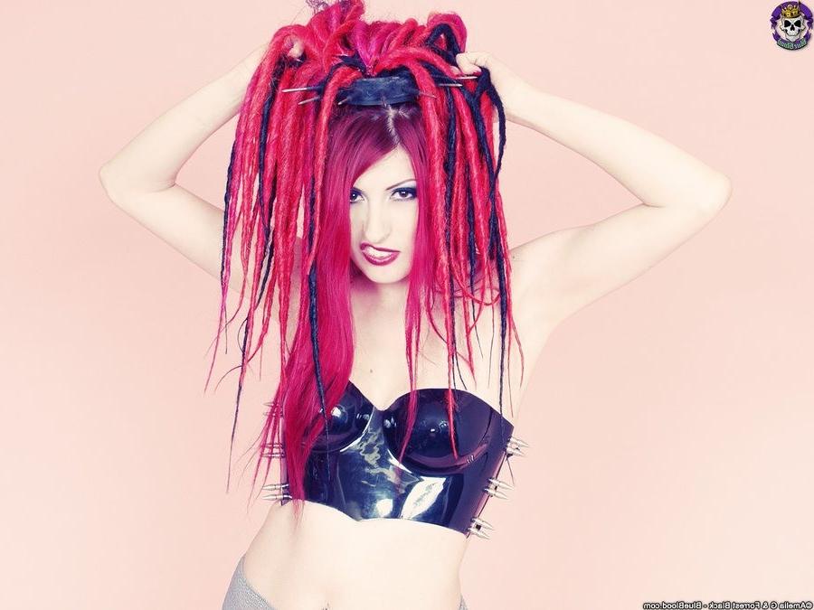 15P Redhaired goth babe babe in a latex top and boots