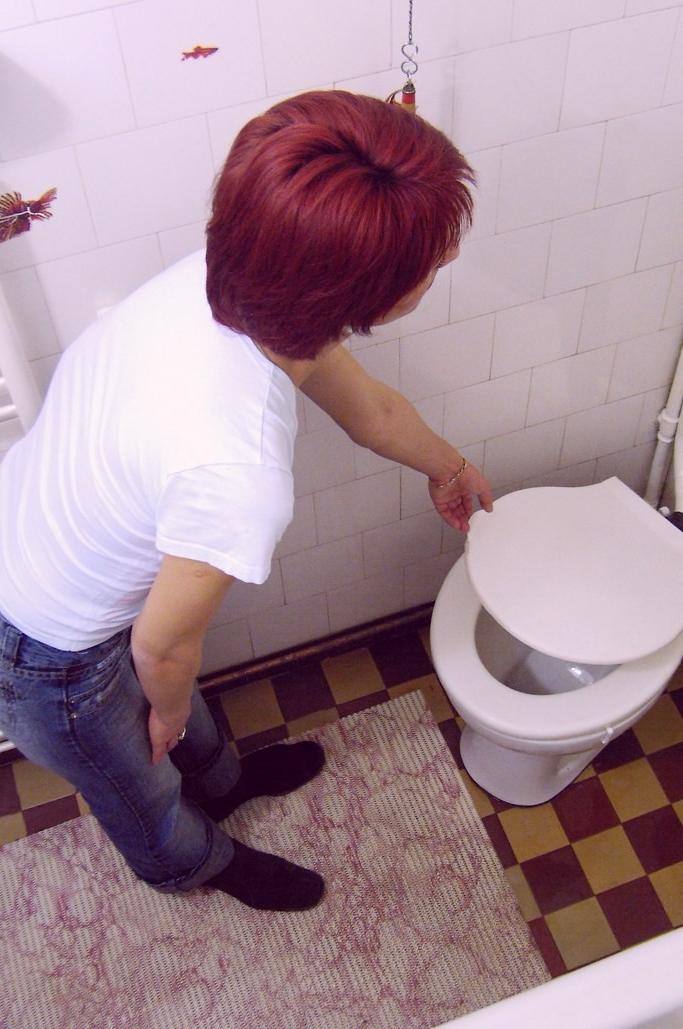 16P Voyeur shots of sexy redhead caught peeing on hidden toilet cam