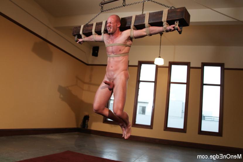15P Muscle stud Mitch Vaughn is suspended crucifix style and edged to a point of ins