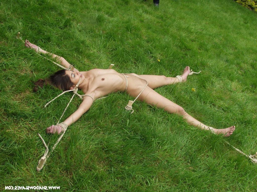 15P Asian slave staked out in the long grass with rope