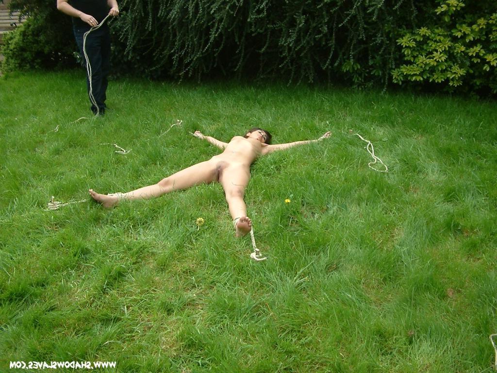 15P Asian slave staked out in the long grass with rope