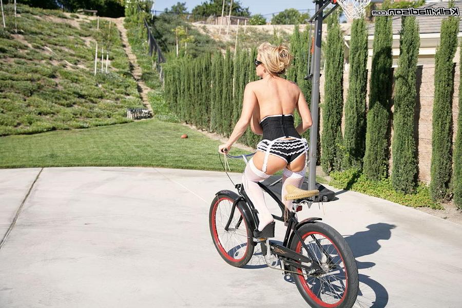 16P Kelly Madison on her bicycle in lingerie