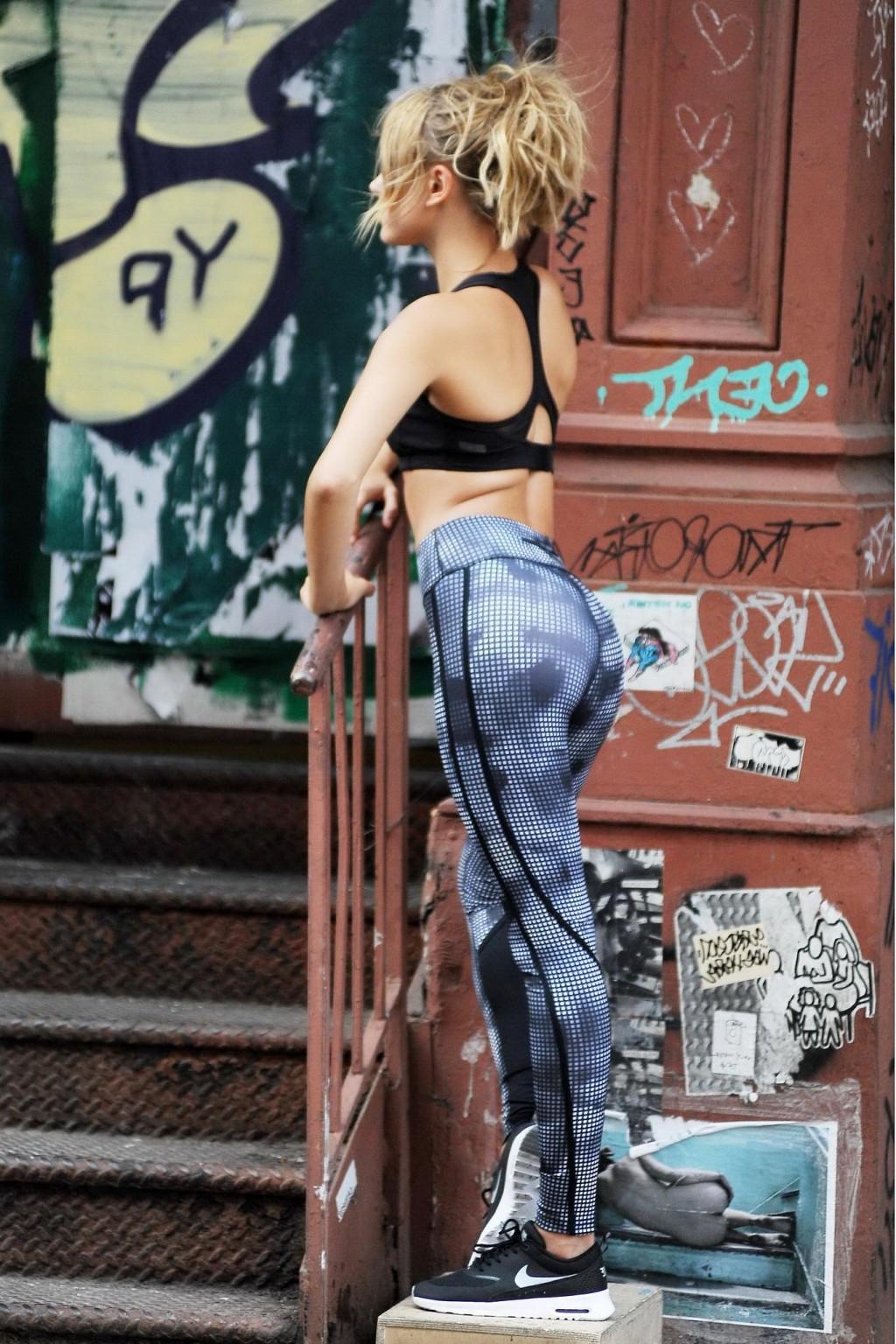 16P Hailey Baldwin wearing sports bra  tights on set