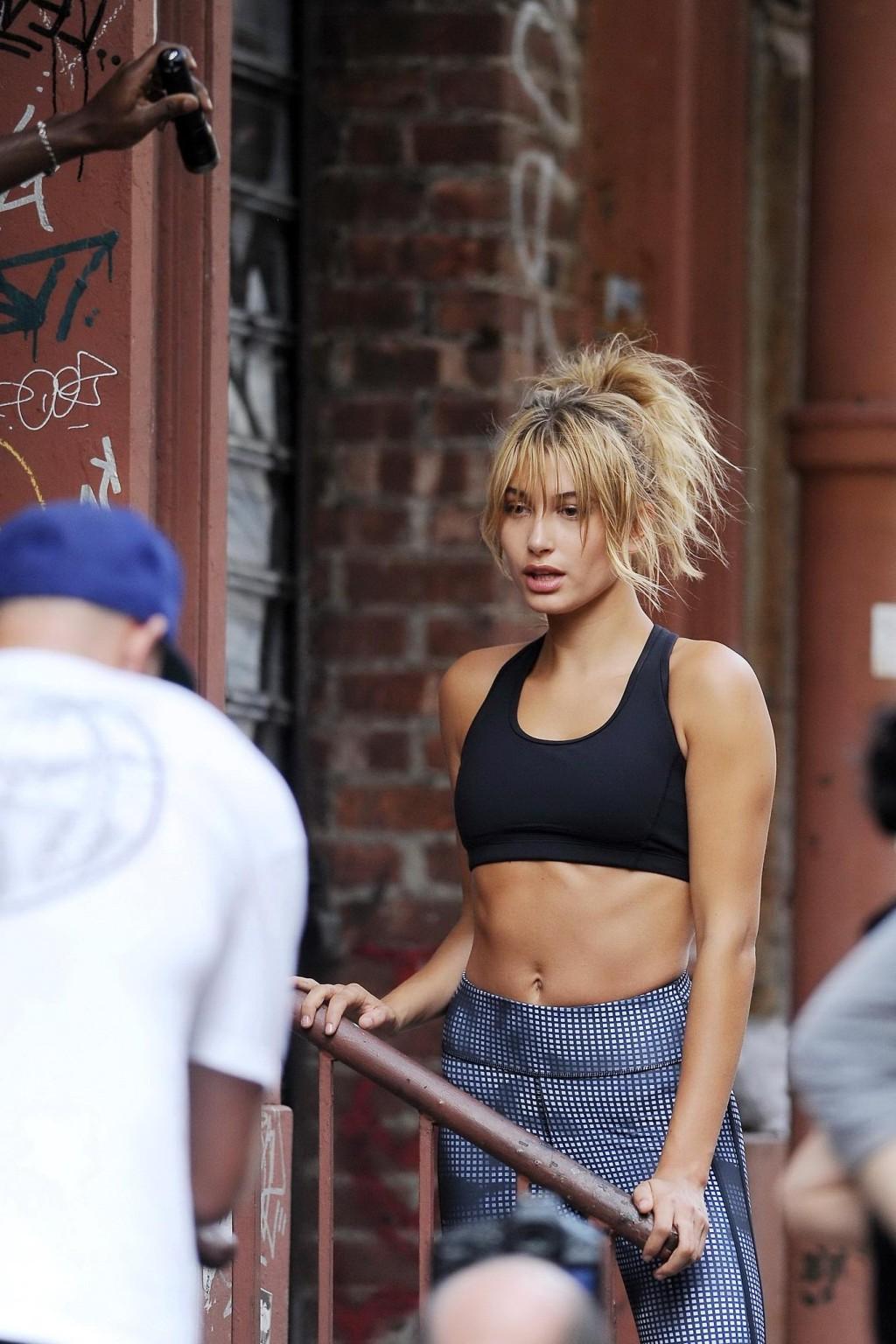 16P Hailey Baldwin wearing sports bra  tights on set