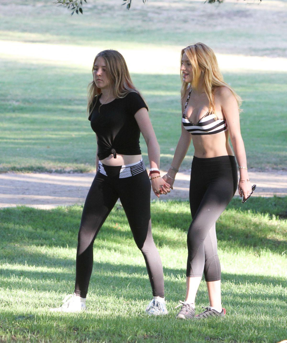 16P Bella Thorne busty in a striped sports bra and tights