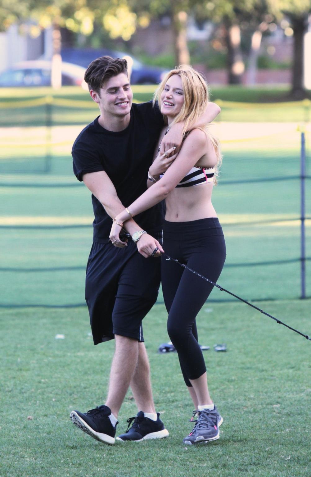 16P Bella Thorne busty in a striped sports bra and tights