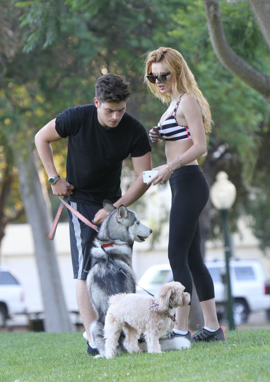 16P Bella Thorne busty in a striped sports bra and tights