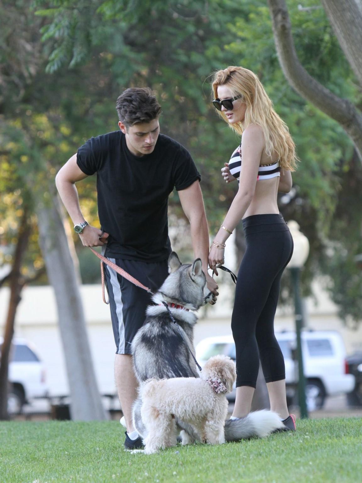 16P Bella Thorne busty in a striped sports bra and tights