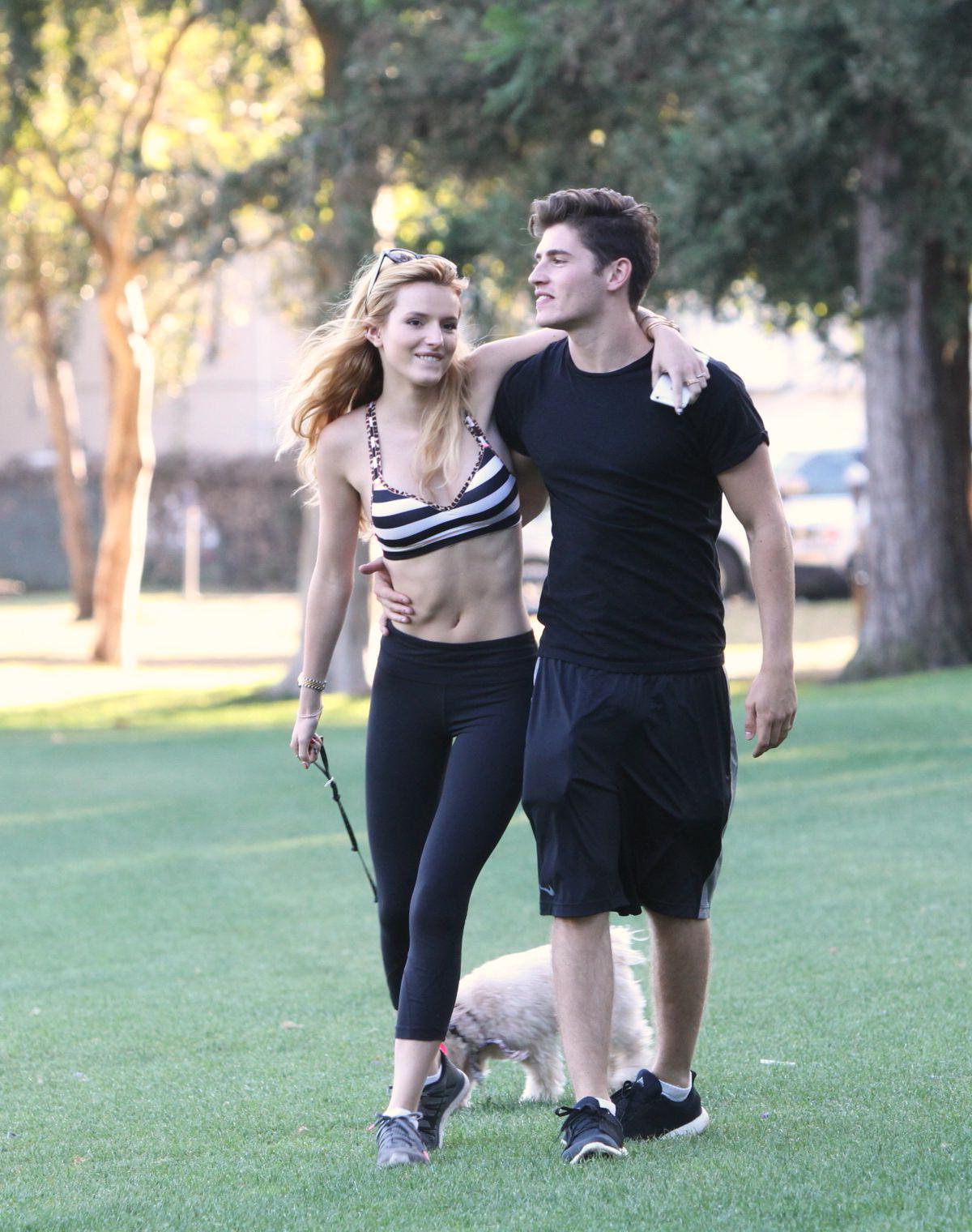 16P Bella Thorne busty in a striped sports bra and tights