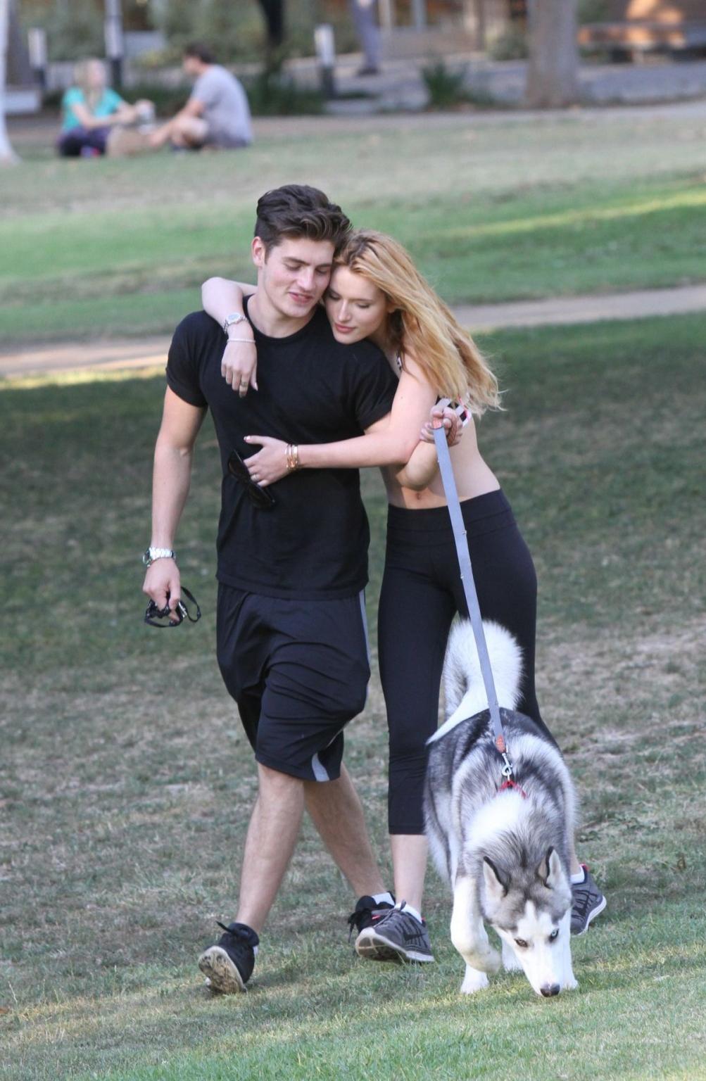 16P Bella Thorne busty in a striped sports bra and tights